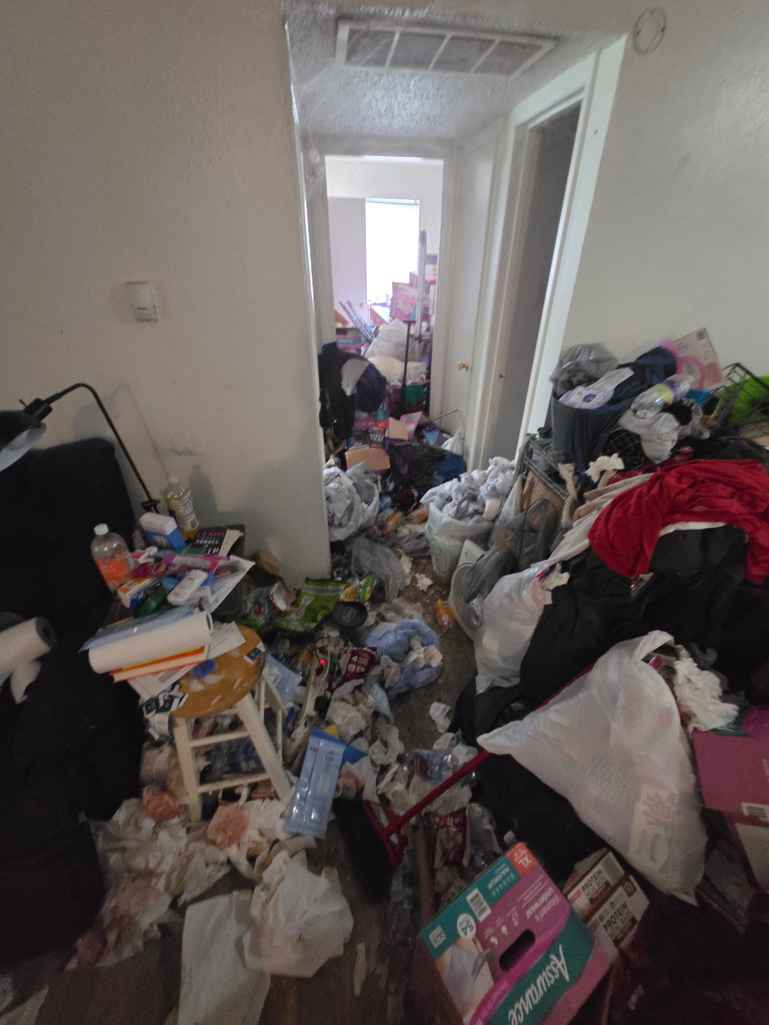 Hallway before a cleanup project completed by Extreme Hoarding Cleaners